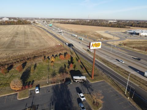 2015 Ford F-550 - An RV and a pickup truck are parked in a lot next to a busy highway, with a prominent Cracker Barrel sign visible.