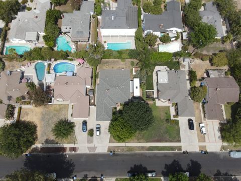 2015 Ford F-550 - Aerial view of a suburban neighborhood with multiple houses and vehicles.