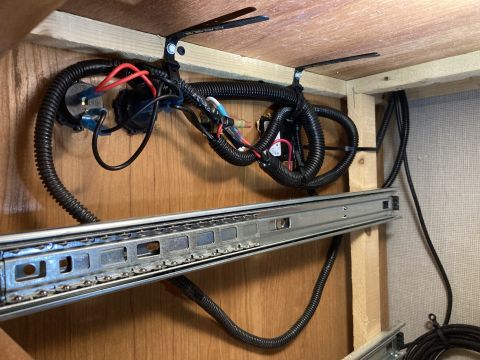 2015 Ford F-550 - This photo shows a close-up of a vehicle's wiring and a drawer slide, not a 2015 Ford F-550.
