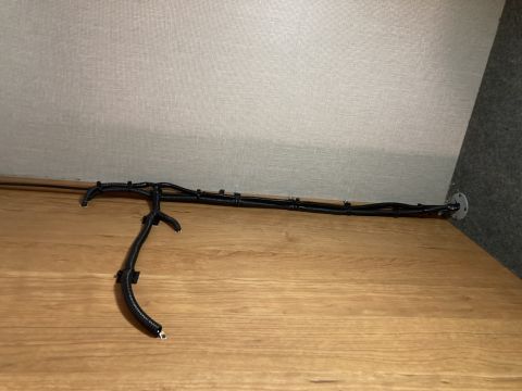 2015 Ford F-550 - A black wiring harness is secured with zip ties to a wooden surface.