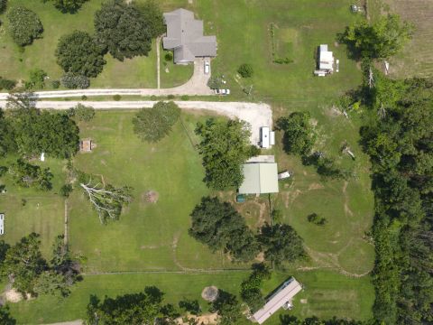 2015 Ford F-550 - Aerial view of a rural property with multiple structures and vehicles visible.