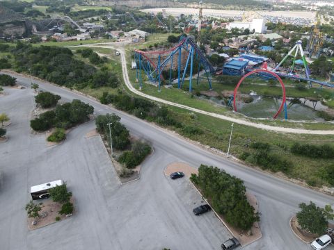 2015 Ford F-550 - An aerial view shows an RV and two cars in a parking lot with a roller coaster in the background.