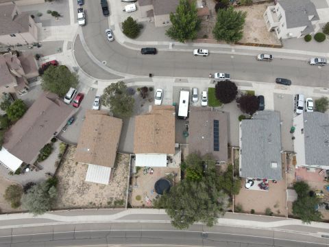 2015 Ford F-550 - An aerial perspective captures a quiet suburban street lined with homes and various vehicles parked in driveways and along the road.