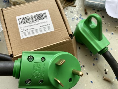 2015 Ford F-550 - RV power adapters and their packaging are shown. The box indicates a replacement plug.
