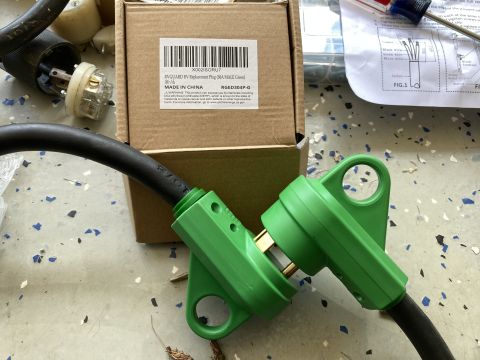 2015 Ford F-550 - Two green RV power cord adapters are shown, along with their packaging and instructions.