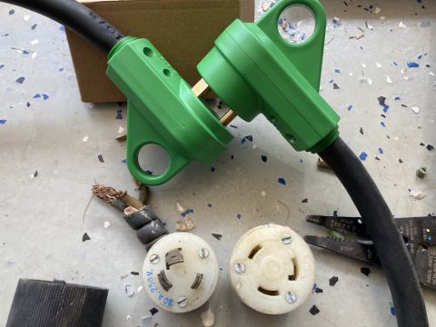 2015 Ford F-550 - Damaged electrical cords and connectors are laid out on a speckled floor, with tools nearby.