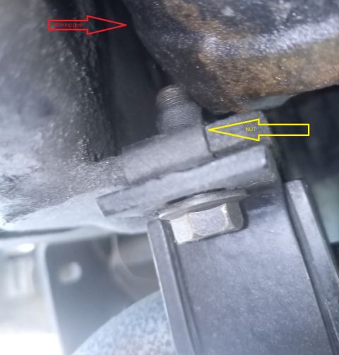 2001 Ford Excursion - This photo shows a close-up view of a vehicle's steering gear and a nut, with arrows pointing to each component.