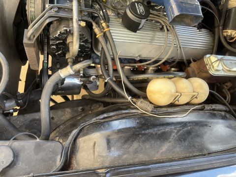 1975 Ford Ranchero - Close-up view of the engine compartment, highlighting mechanical components and the Ford branding on the air cleaner.