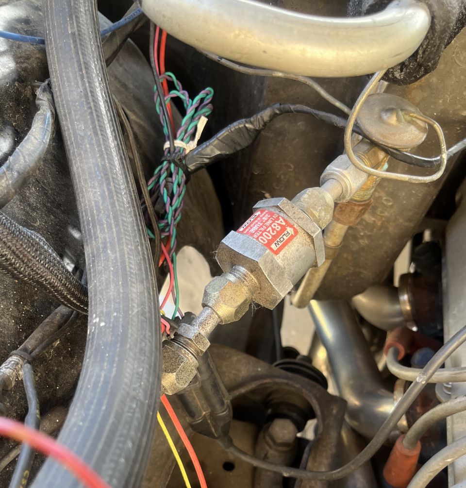Close-up of a fuel filter labeled A8200 in an engine bay