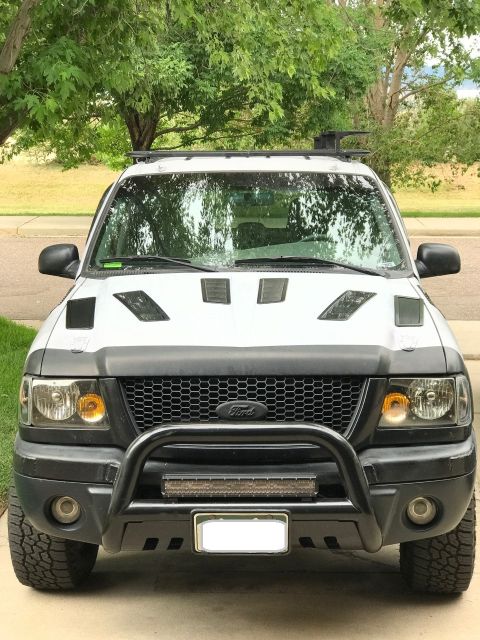 2000 Ford Explorer - This Ford Ranger pickup truck features a custom grille and hood vents, differing from the claimed Explorer model.