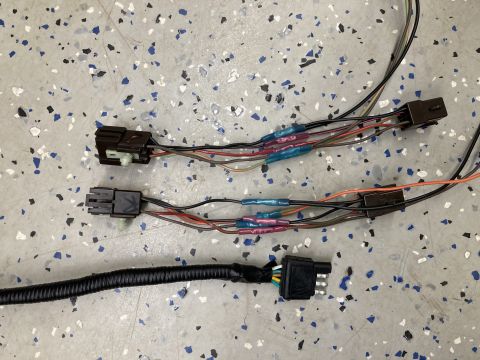 2015 Ford F-550 - Close-up view of an automotive wiring harness several connectors and spliced wires with heat-shrink tubing.
