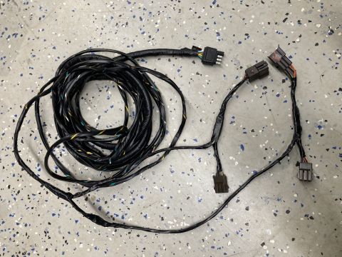 2015 Ford F-550 - A vehicle wiring harness is shown laid out on a speckled floor.