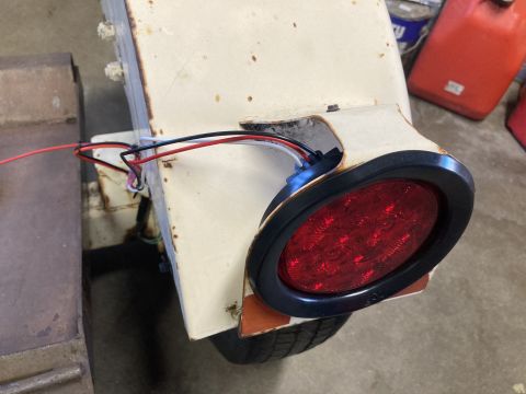 2015 Ford F-550 - A close-up view of a trailer's red LED tail light assembly, showing its wiring and mounting.