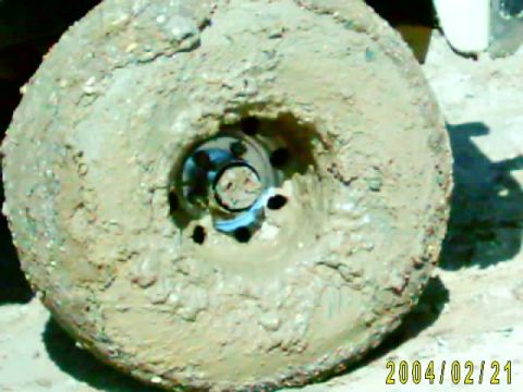 1985 Ford Bronco - This wheel is completely covered in mud, suggesting it was used in a challenging off-road environment.
