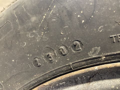 2015 Ford F-550 - Close-up of a tire sidewall displaying the DOT code 2302, indicating it was manufactured in the 23rd week of 2002.