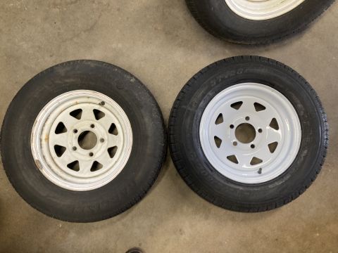 2015 Ford F-550 - Two trailer wheels and tires are shown on a concrete surface.