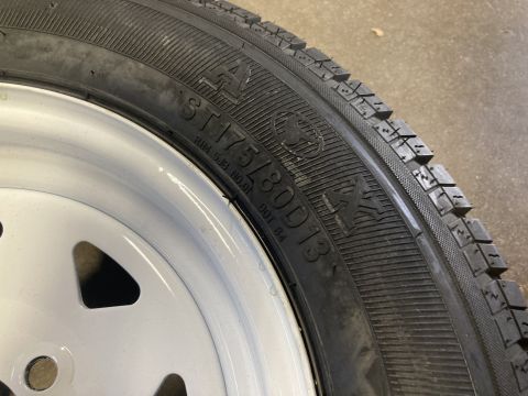 2015 Ford F-550 - A close-up view of a ST175/80D13 tire mounted on a white wheel.