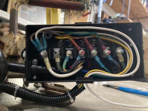 2015 Ford F-550 - A close-up view of a vehicle's wiring harness within a black junction box, showing various colored wires and terminal connections.