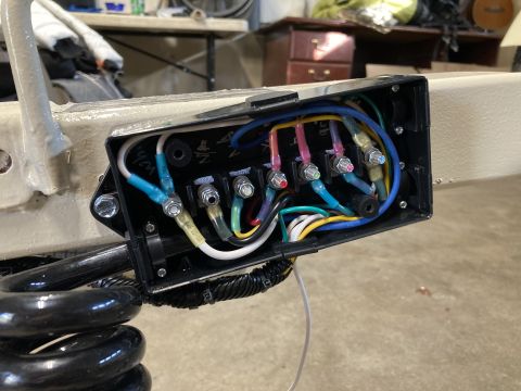2015 Ford F-550 - Close-up view of a vehicle's wiring harness junction box, showing various colored wires connected to terminals.
