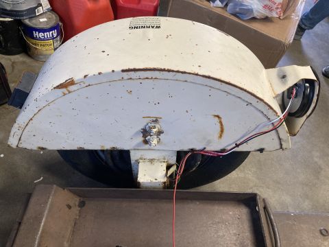 2015 Ford F-550 - A white trailer fender shows signs of rust and wear, with electrical wiring connected to a light assembly.