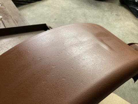 2015 Ford F-550 - Close-up of a textured brown automotive part, showing surface imperfections and wear.