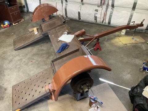 2015 Ford F-550 - Trailer frame and parts are being painted in a workshop setting.