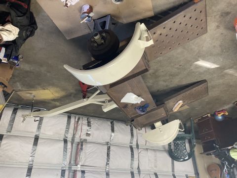 2015 Ford F-550 - A vehicle fender and wheel are disassembled and supported by a stand in a garage setting.