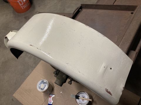 2015 Ford F-550 - A truck fender is shown with paint supplies, suggesting a repair or restoration process.