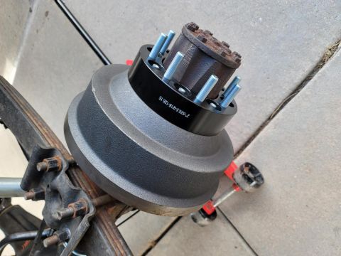 1996 Ford Bronco - A black wheel spacer is mounted on a drum brake assembly, showing the part number '2-8X6.5-8/126-15'.