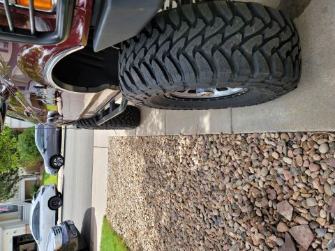 1996 Ford Bronco - Close-up of a 1996 Ford Bronco's large off-road tire and fender flare.