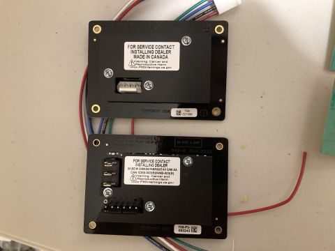 2015 Ford F-550 - Two electronic control modules, likely for a vehicle system, are shown with visible wiring and service contact information.