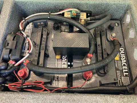 2015 Ford F-550 - A close-up view of a vehicle's house battery setup, showing two connected batteries and wiring.