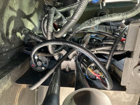 2015 Ford F-550 - Close-up view of an air horn assembly, numerous black wires and electrical connectors.