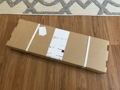 2015 Ford F-550 - A cardboard box is shown on a wooden floor, with a rug in the background.