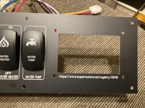 2015 Ford F-550 - A close-up of a vehicle's control panel shows switches for water heater and water pump, along with a registry URL.