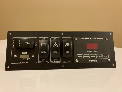 2015 Ford F-550 - A control panel for a vehicle's systems, including tank monitoring and power switches.