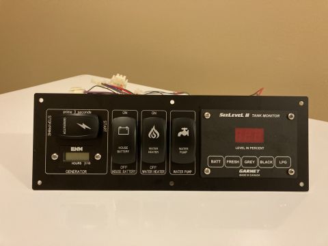 2015 Ford F-550 - This monitor panel features controls for various RV systems and a digital display for tank levels.