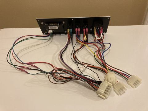 2015 Ford F-550 - A complex wiring harness is attached to a switch panel, various connectors and colored wires.