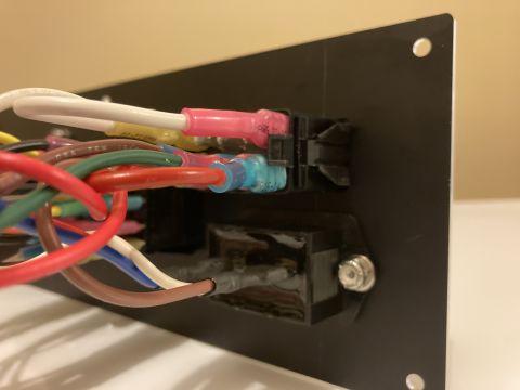 2015 Ford F-550 - A complex wiring harness with multiple colored wires connects to a black fuse box panel.