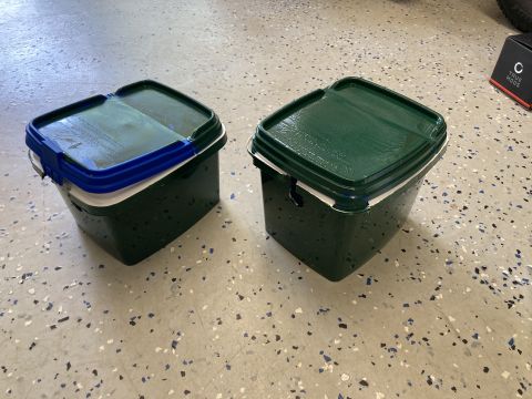 2015 Ford F-550 - Two green buckets with lids are on a speckled floor. The album claims they are related to a 2015 Ford F-550.