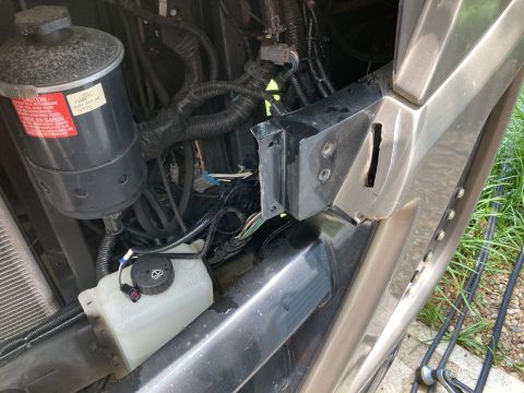 2015 Ford F-550 - Engine bay components including a fluid reservoir and wiring harness are visible.