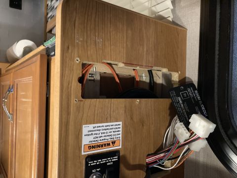 2015 Ford F-550 - Close-up of an interior panel showing wiring, a propane detector warning, and a room slideout control tag.