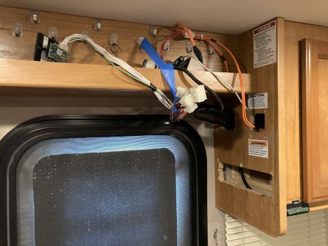 2015 Ford F-550 - Exposed wiring and control components are visible on a wooden panel inside a vehicle.