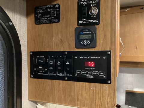 2015 Ford F-550 - RV control panel displays tank levels and operates various systems like water pump and generator.
