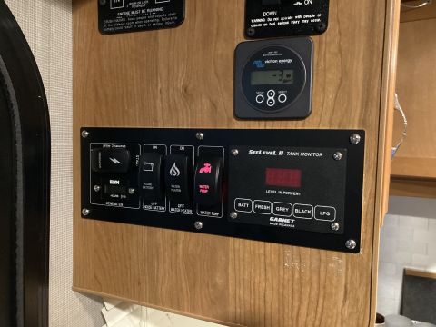 2015 Ford F-550 - This interior panel displays controls for various RV systems, including tank levels and power management.