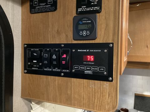 2015 Ford F-550 - RV interior panel with SeeLevel II tank monitor and various control switches.