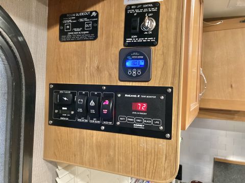 2015 Ford F-550 - This RV control panel shows various system statuses and controls, including tank levels and battery voltage.