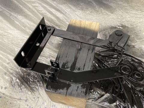 2015 Ford F-550 - Black painted hood brackets are shown on wooden blocks, covered in plastic sheeting.