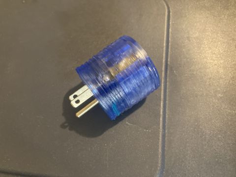 2015 Ford F-550 - A close-up view of a blue power plug with visible metal prongs.