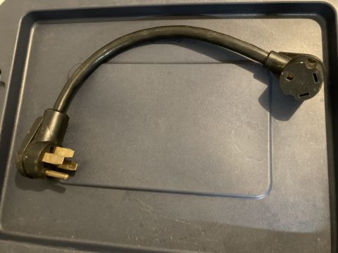 2015 Ford F-550 - This black power cord adapter features two distinct plug configurations for electrical connections.